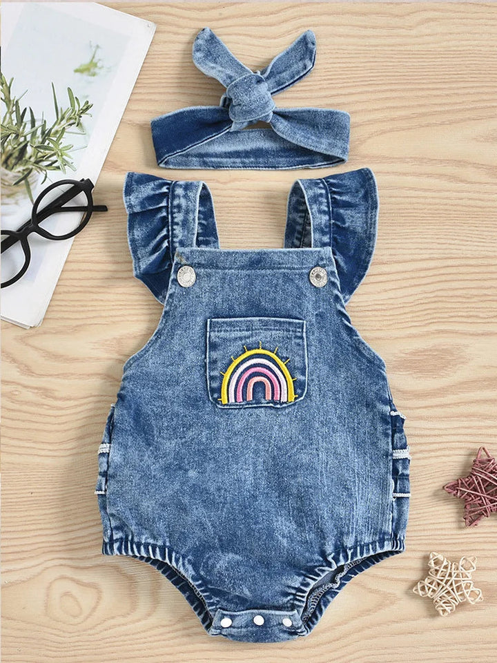 Front of blue denim romper with a rainbow pocket, flutter straps and matching bow headband