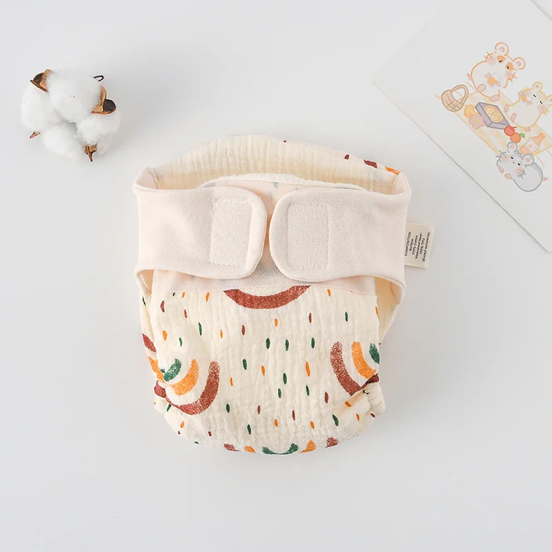 Rainbow-and-raindrop print cloth diaper with cream fastening tabs