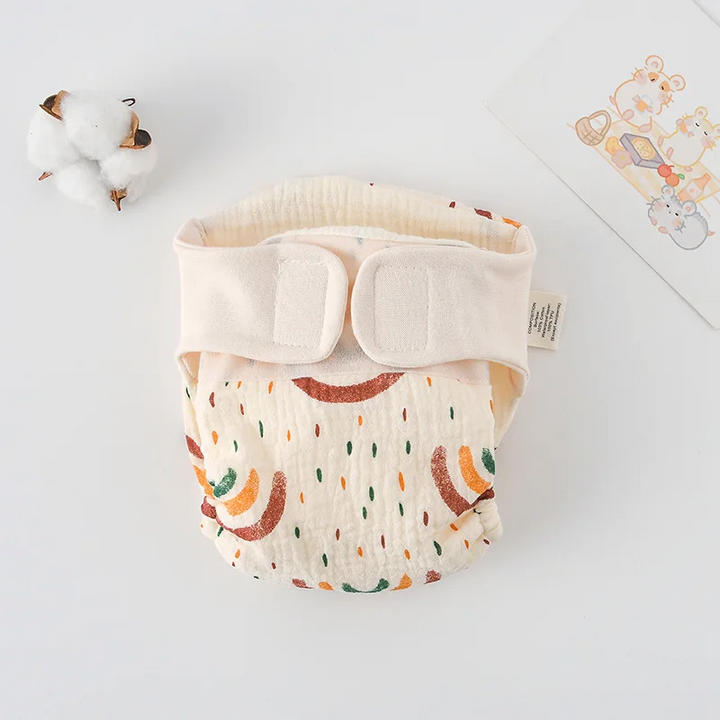 Rainbow-and-raindrop print cloth diaper with cream fastening tabs