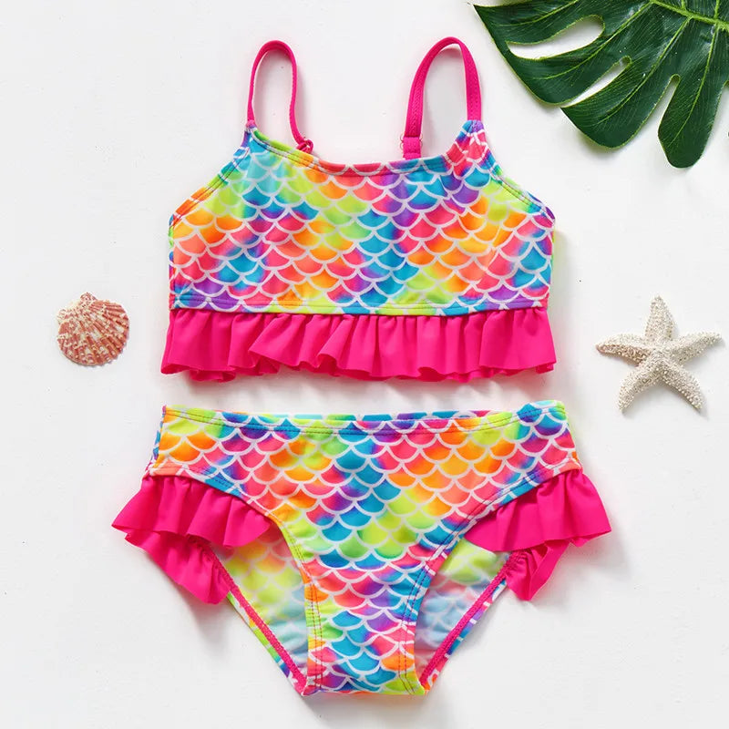 Rainbow scale-print bikini set with bright pink straps and ruffles on the top and bottoms.
