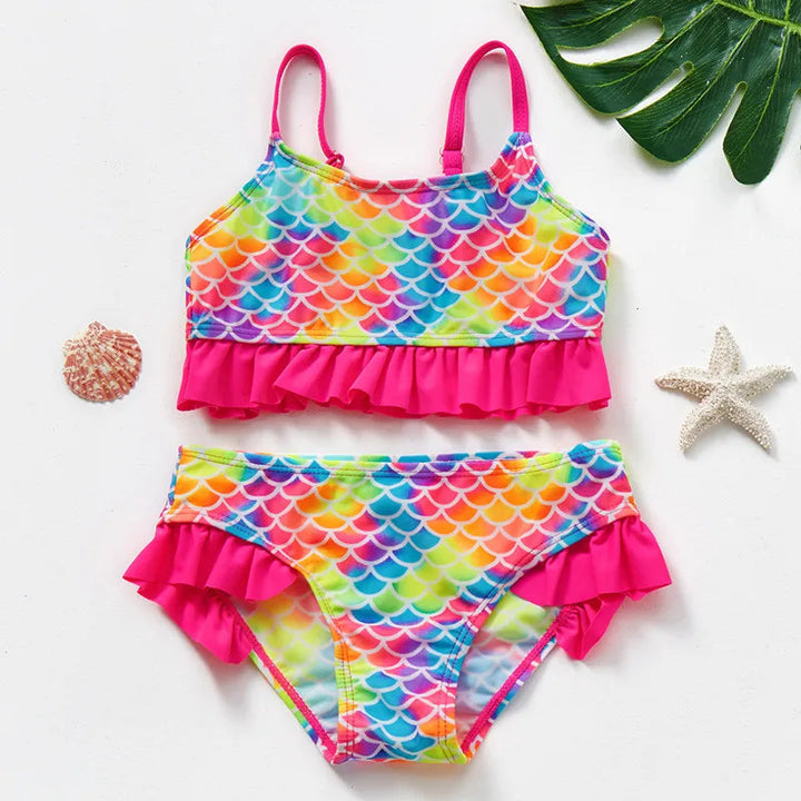 Rainbow scale-print bikini set with bright pink straps and ruffles on the top and bottoms.