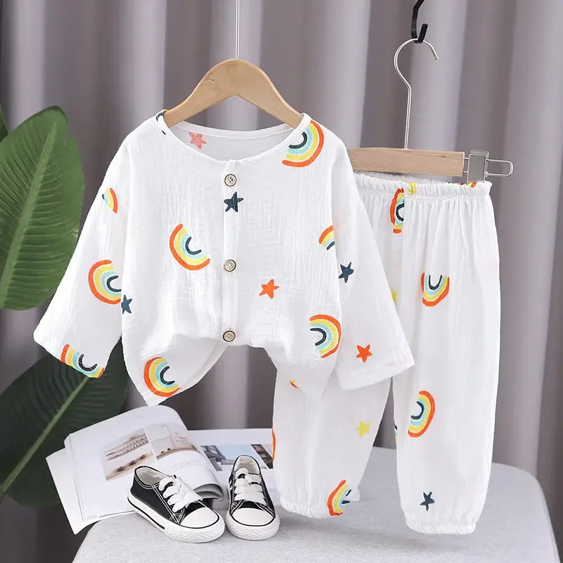 White button-front pajama top and matching pants with colorful rainbow and star prints