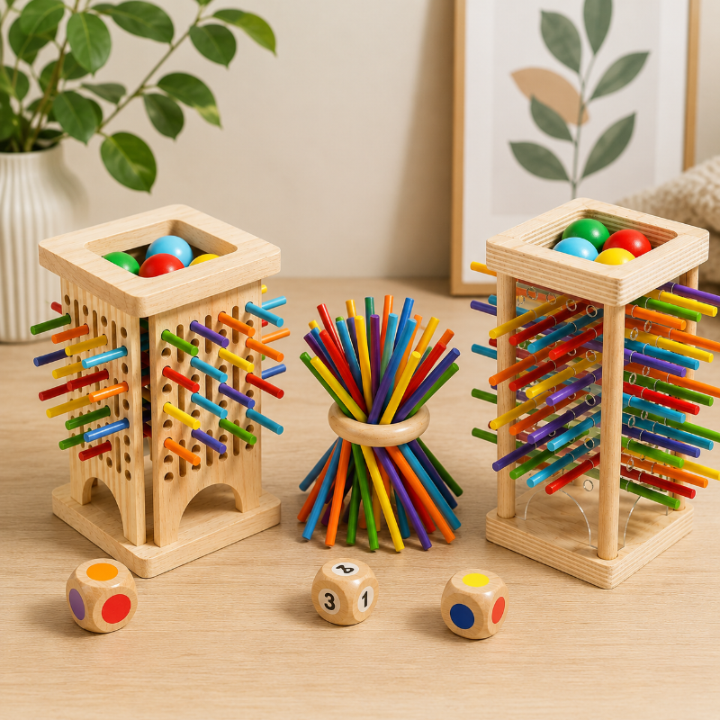 Two wooden stick towers, a balancing-stick ring game, colored balls, and dice arranged on a table.
