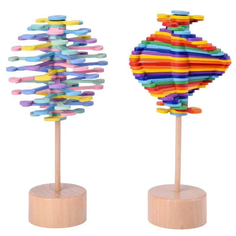 Two multicolor wooden rotating lollipop toys with differently arranged layers and round wooden bases