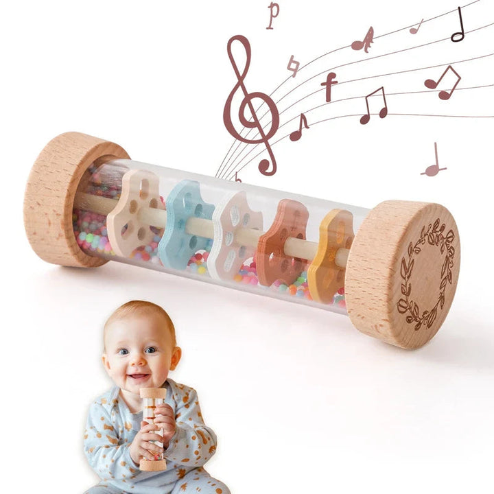Rainstick rattle with wooden ends and colorful beads, with a baby holding the toy below
