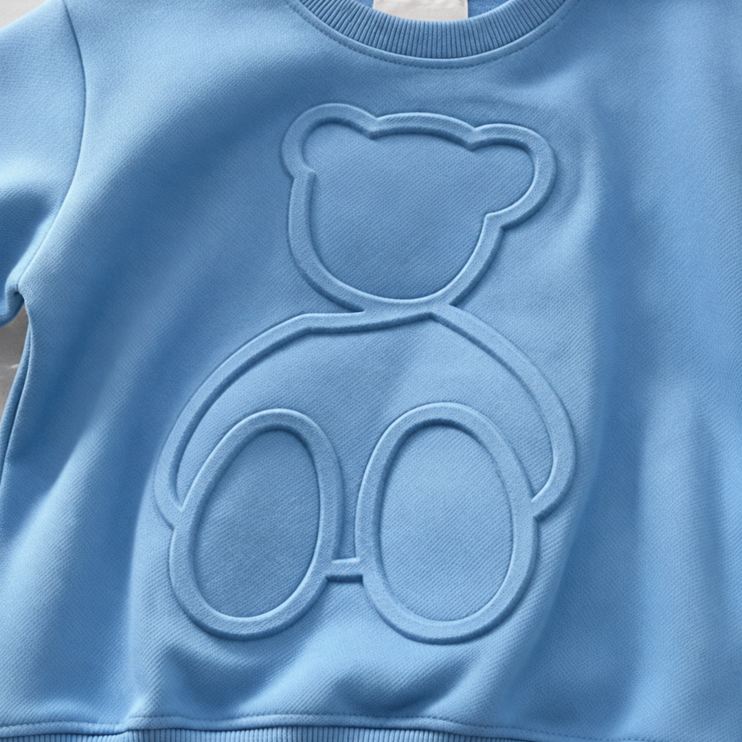 Raised bear outline across the front of the blue kids&