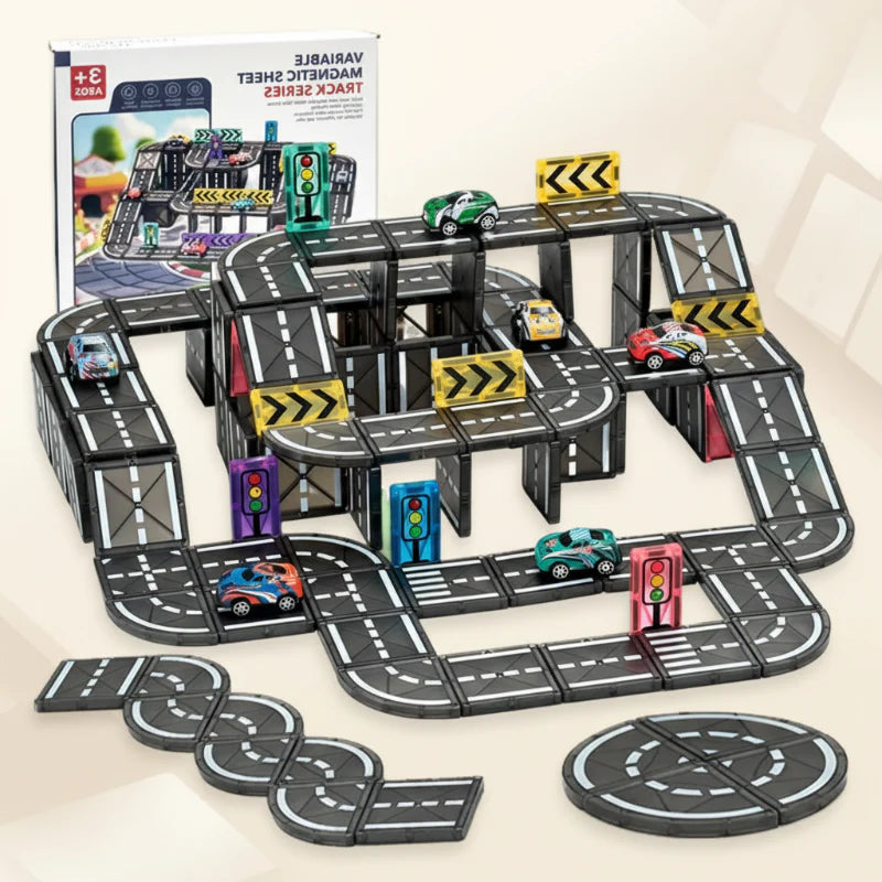 Elevated magnetic road layout with toy cars, traffic signs, and loose road tiles beside its box