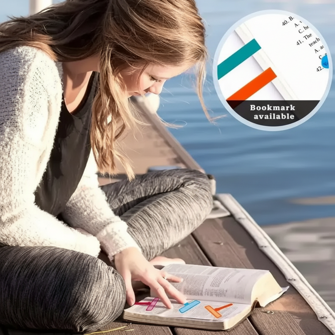Reader outdoors with colored reading guides marking pages in an open book.