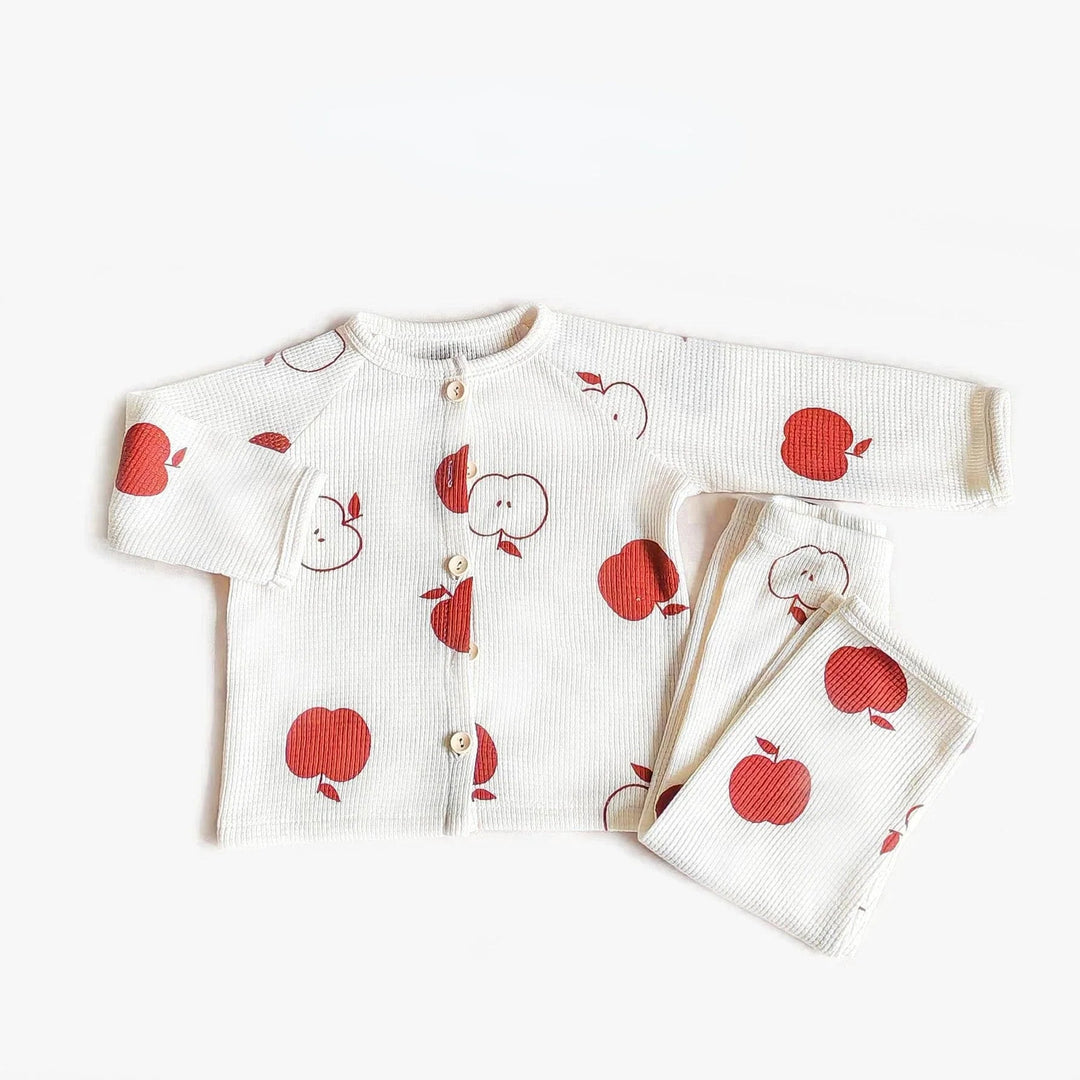 White cotton pajama set with red and outlined apple prints