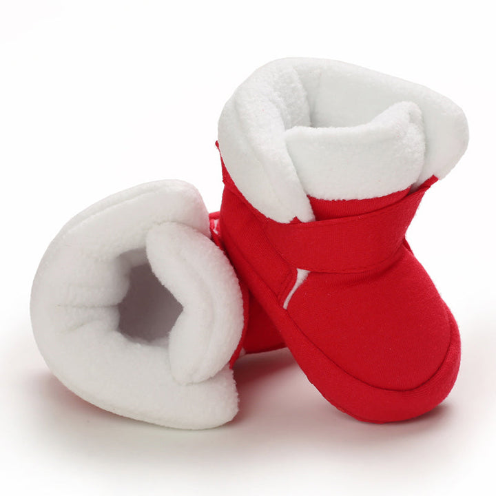 Red baby booties with wide white cuffs and wraparound ankle straps
