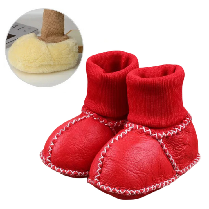 Red baby slippers with matching rolled knit cuffs and white stitching
