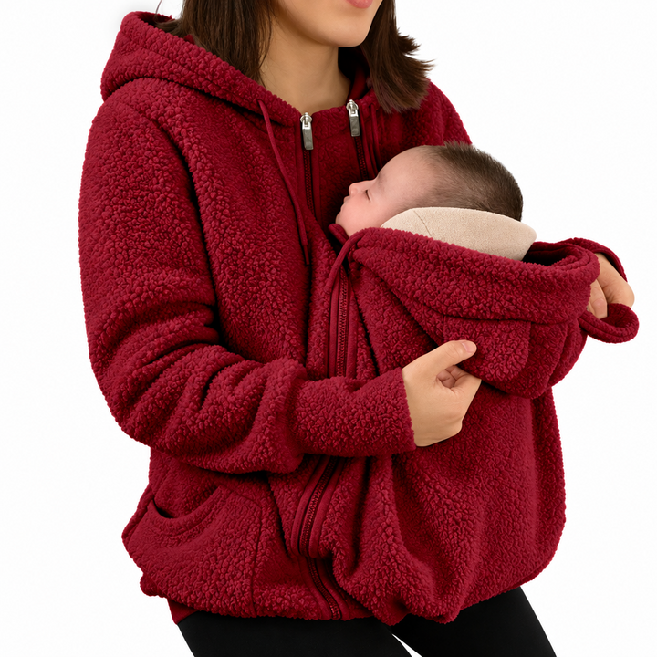 Red hooded babywearing jacket shown with a baby in front