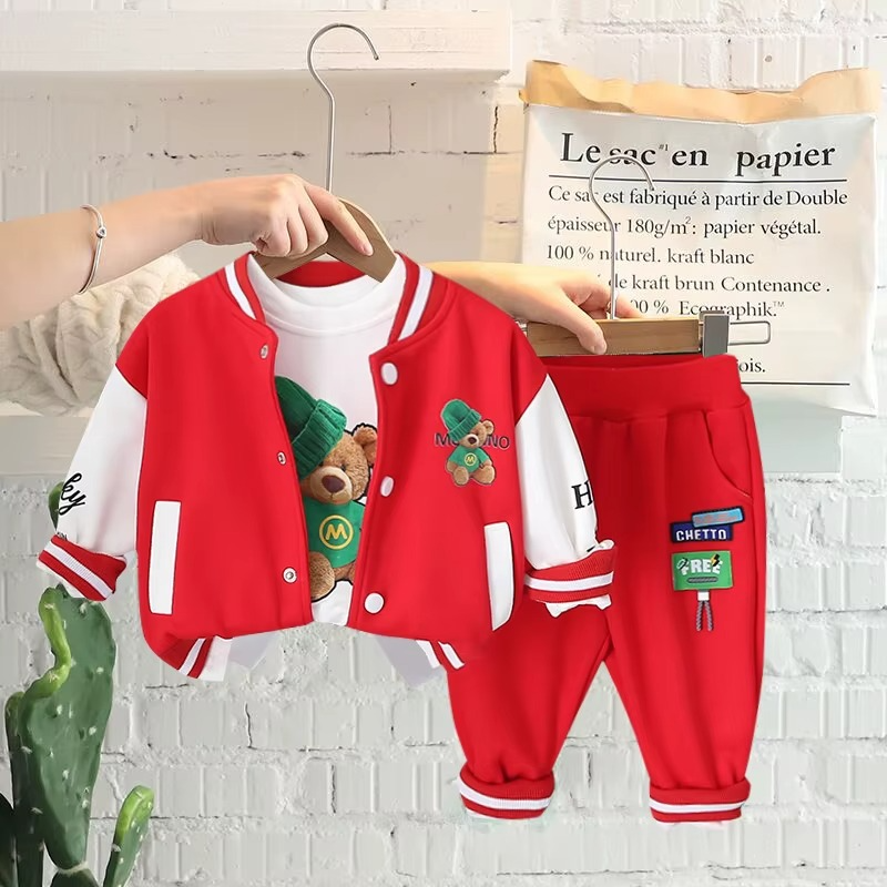 Red-and-white bear varsity jacket, graphic T-shirt, and matching red pants on hangers