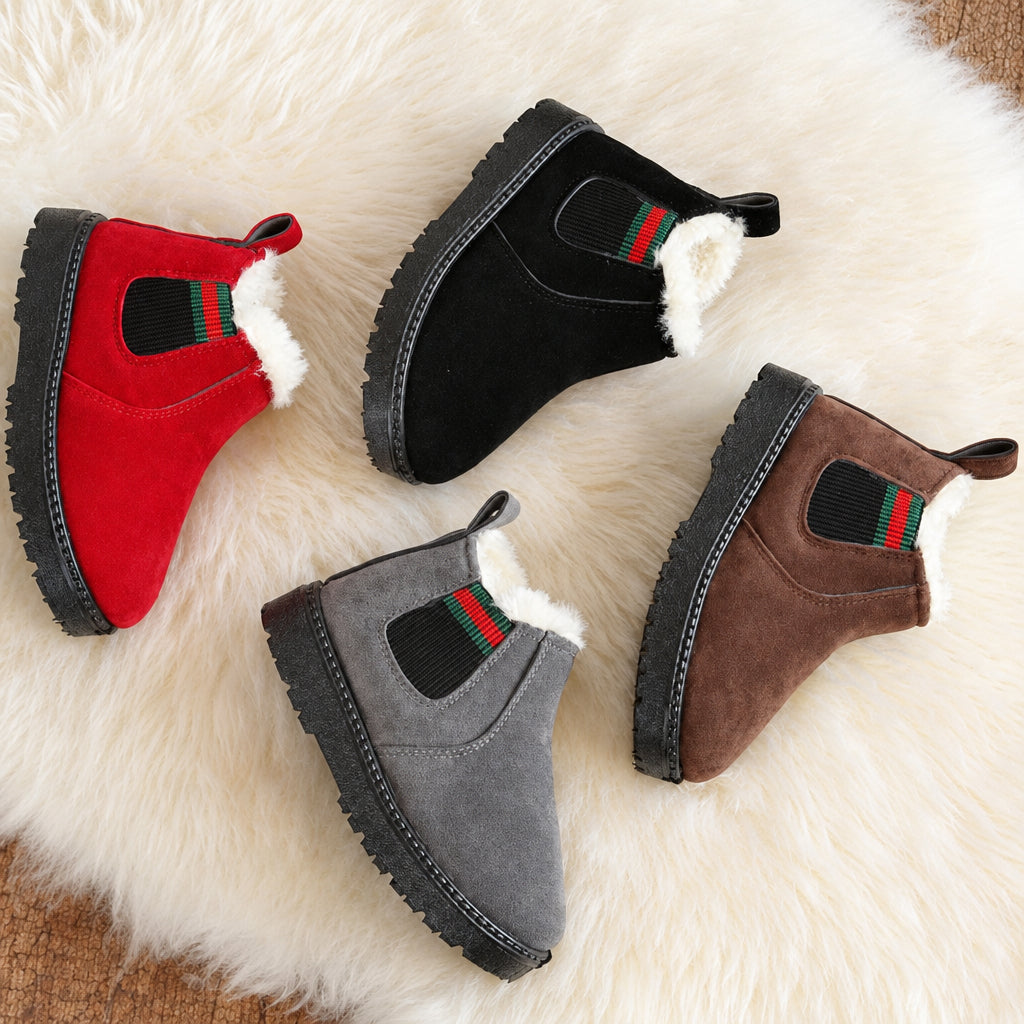 Red, black, gray, and brown suede winter boots arranged on a white rug.