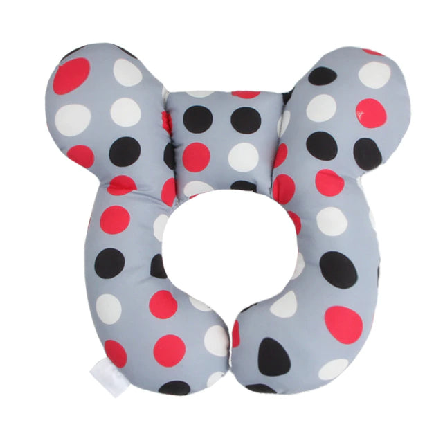 Front view of a gray butterfly-shaped pillow with red, black, and white dots