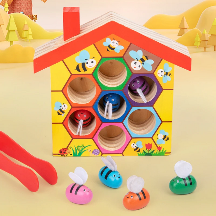 Upright wooden sorting hive with red, blue, and purple bees in matching openings