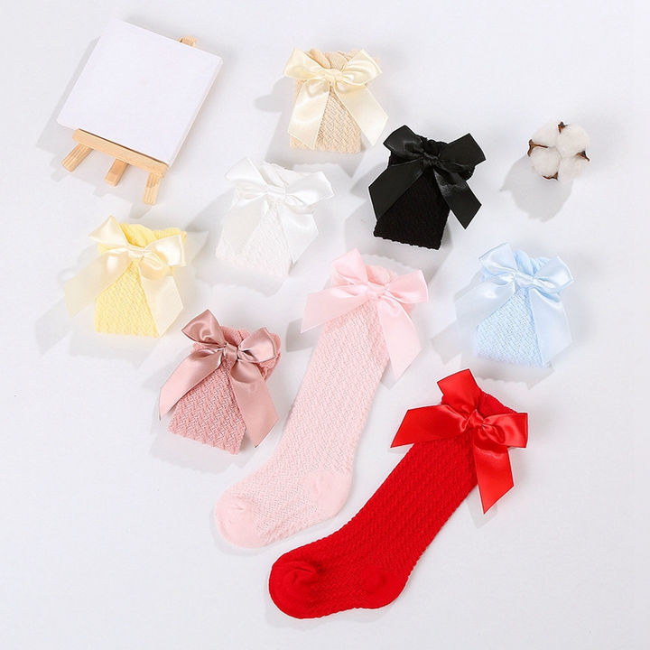 Colorful bow knee-high socks with a red sock displayed at the front