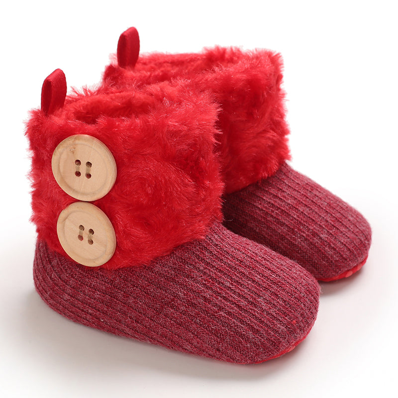 Red baby winter boots with plush cuffs and contrasting button accents