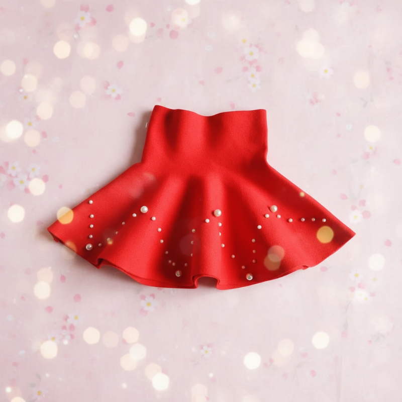 Red knit skirt with pearl-style beads arranged in chevron patterns