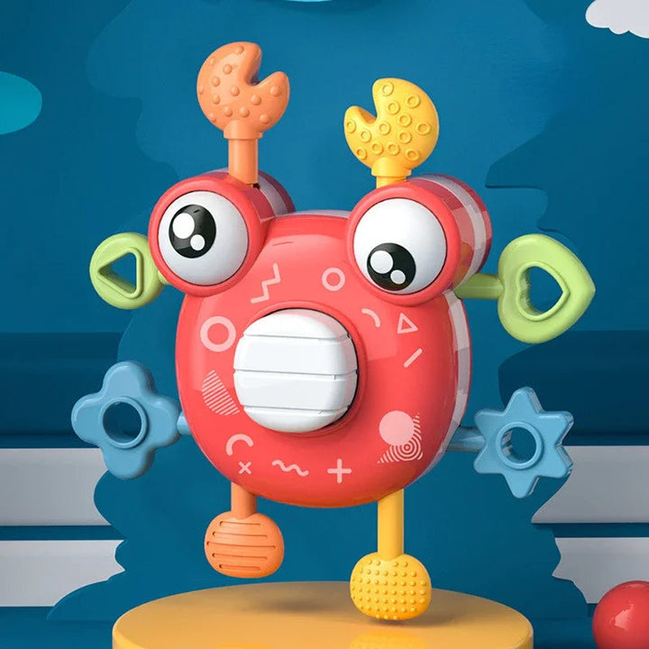 Red crab sensory toy with a white center button, green side rings, and textured claws