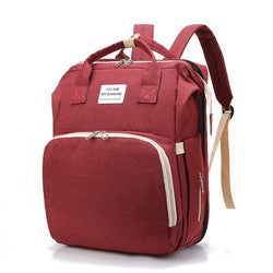 Red diaper backpack with front zip pocket, top handles and shoulder straps