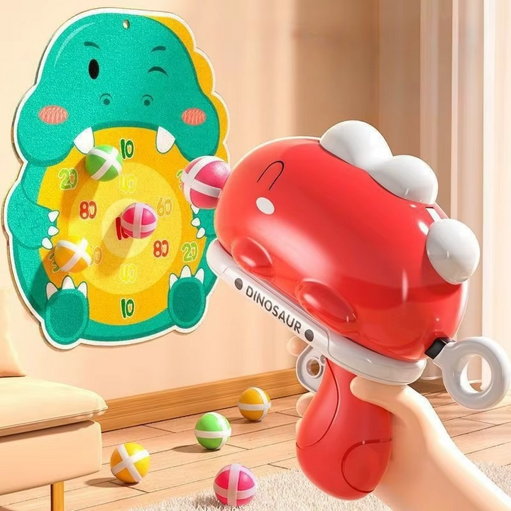 Handheld red dinosaur ball launcher aimed at a hanging dinosaur target