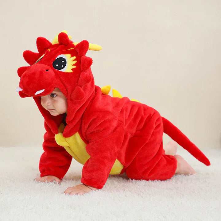 Baby crawling in a red dragon romper with yellow back spikes and a long tail.