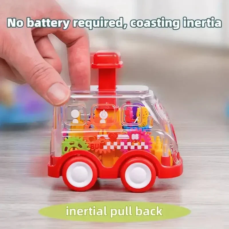 Hand touching a red fire truck toy with a clear body, colorful gears, and a red top button