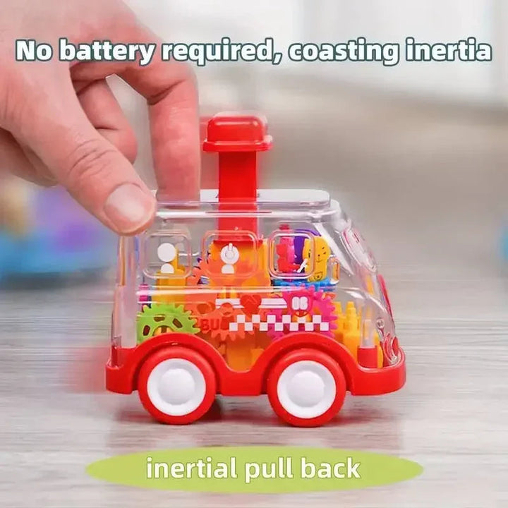 Hand touching a red fire truck toy with a clear body, colorful gears, and a red top button