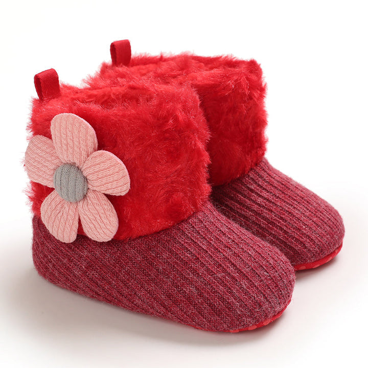 Red baby winter boots with plush cuffs and pink flower accents