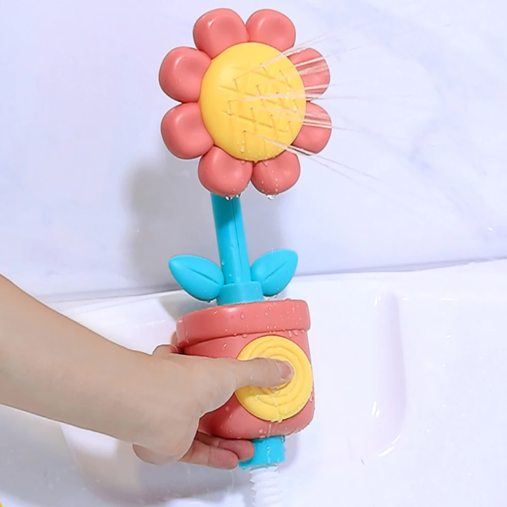 Red flower bath toy with a turquoise stem and a yellow button being pressed to spray water