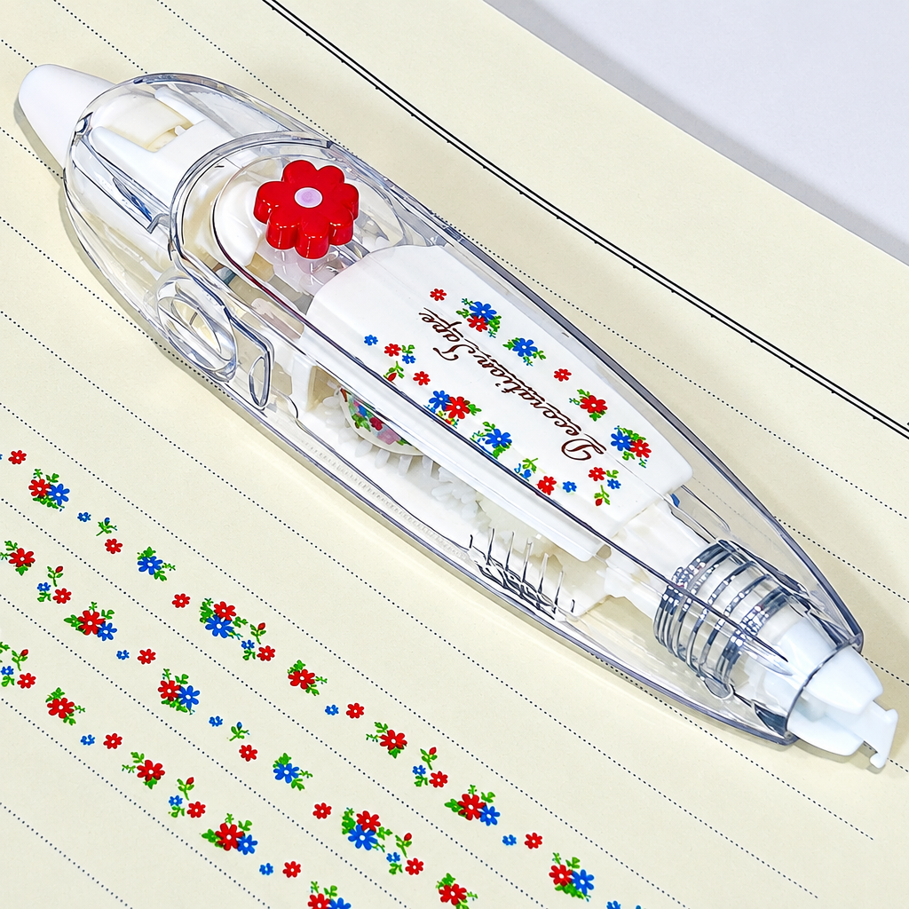 Clear decorative tape dispenser with a red flower detail beside rows of small multicolor flowers.