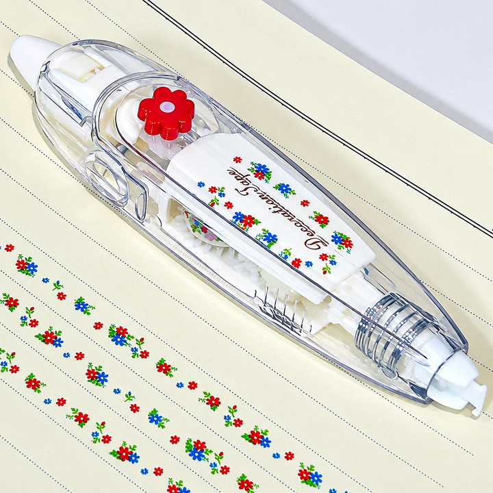 Clear decorative tape dispenser with a red flower detail beside rows of small multicolor flowers.