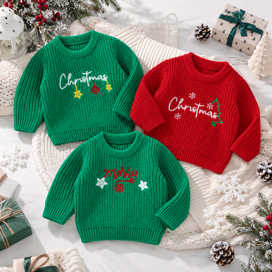 Three red and green baby Christmas sweaters with embroidered holiday designs laid out together.