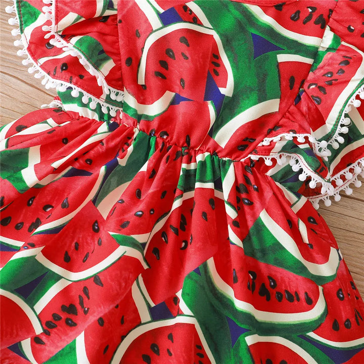 Close-up of red and green watermelon print, gathered fabric and white decorative trim
