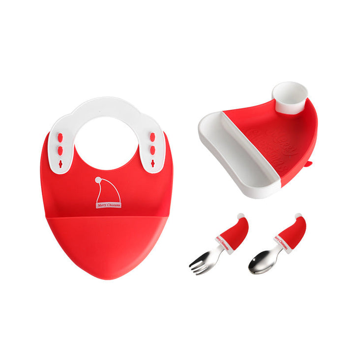Red holiday bib, hat-shaped divided plate, fork, and spoon on a white background