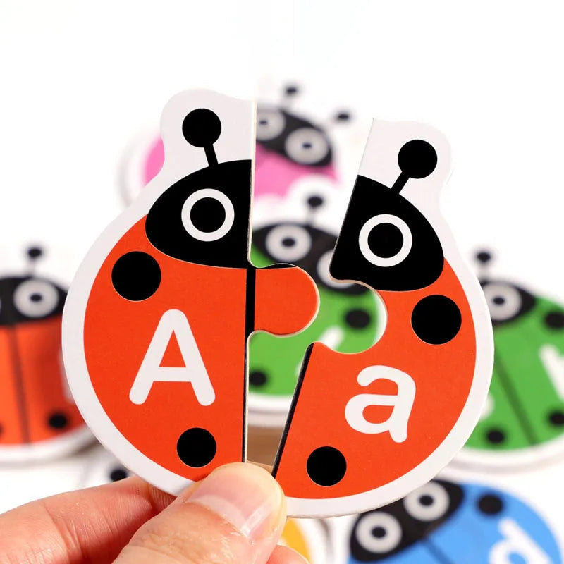 Hands holding a red wooden ladybug puzzle with uppercase A and lowercase a