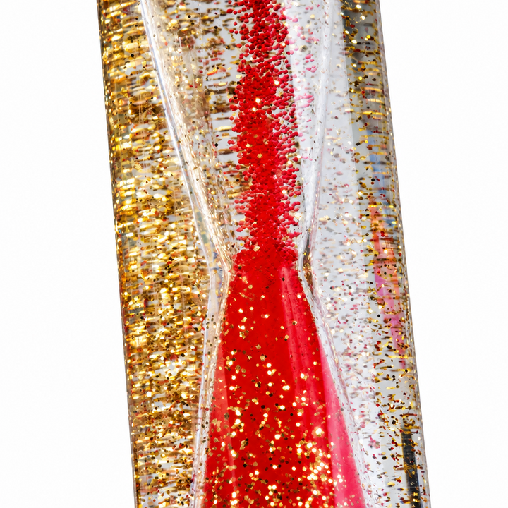 Close-up of red liquid and gold glitter inside a clear sensory tube