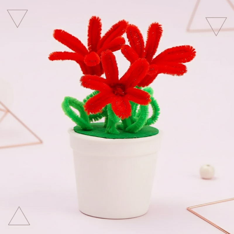 Red fuzzy-wire flowers with long looped petals and green stems in a white pot