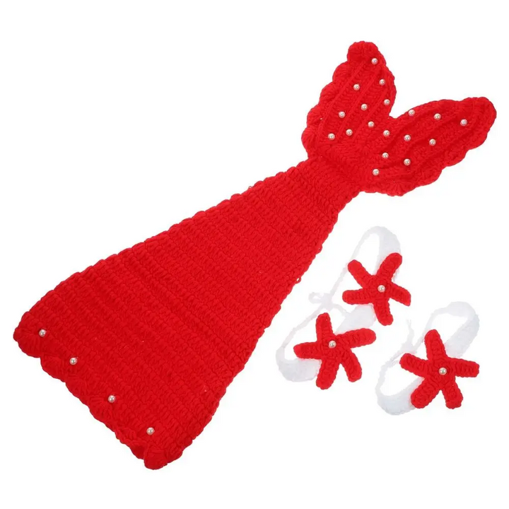 Red mermaid tail with a wide decorated fin beside white bands with red starfish accents