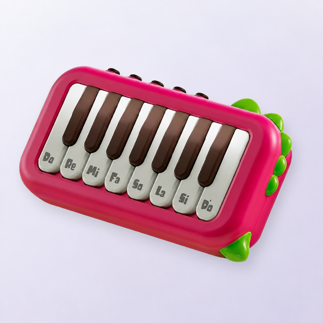 Red mini electronic piano with note-labeled keys and green corner accents.
