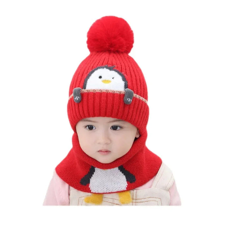 Child wearing a red penguin pom-pom hat and scarf on a white background
