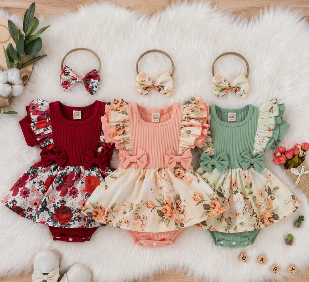 Red, pink and green baby rompers showing floral skirts, ribbed tops and matching headbands