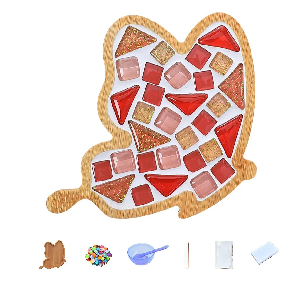 Tall mosaic coaster with red, pink and gold-tone tiles, shown with crafting supplies