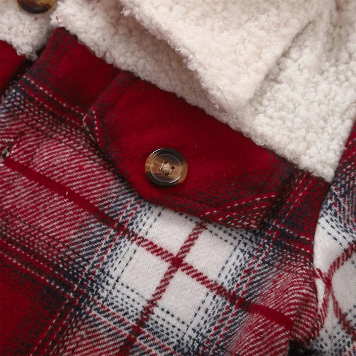 Red plaid jacket chest pocket with a brown button below the cream textured collar