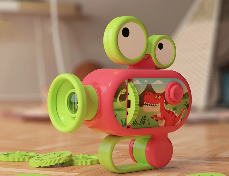 Red toy projector with green trim and projection slides on a wooden table