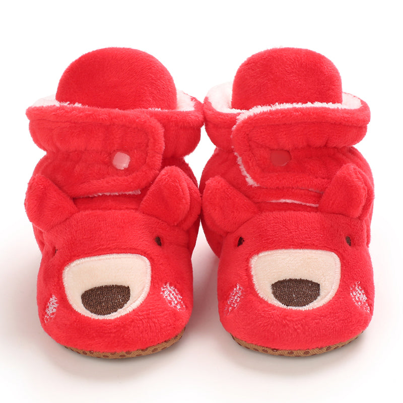 Red baby slippers with reindeer faces, rounded muzzles and plush cuffs