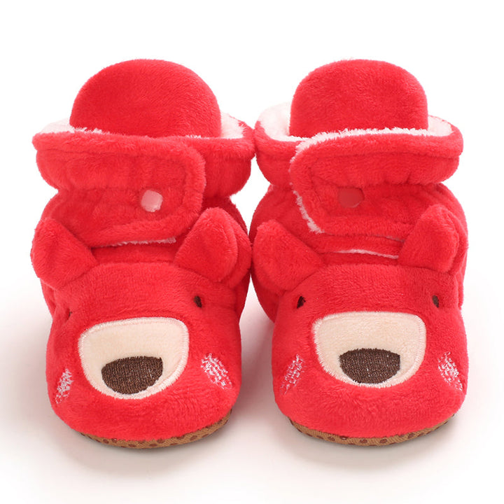 Red baby slippers with reindeer faces, rounded muzzles and plush cuffs