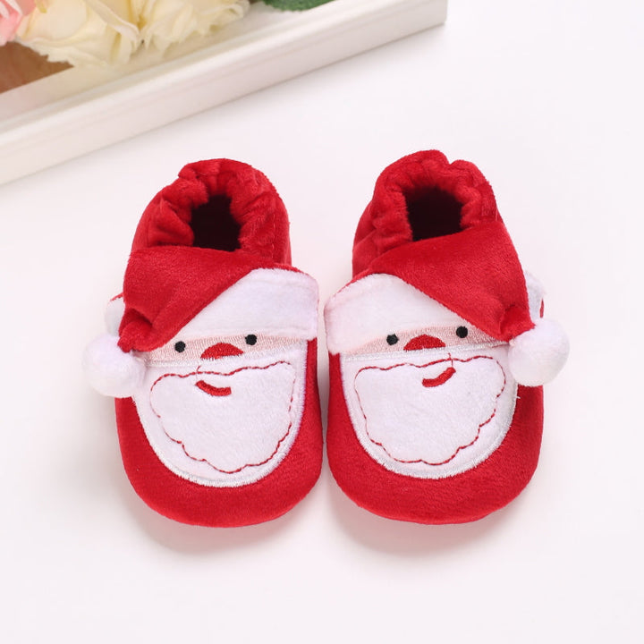 Red baby slippers with white Santa faces and red hat details
