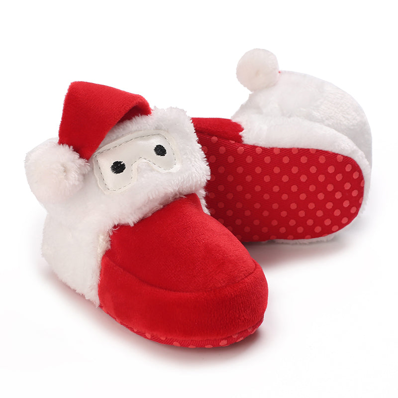 Red baby slippers with Santa faces, fluffy white trim and dotted soles